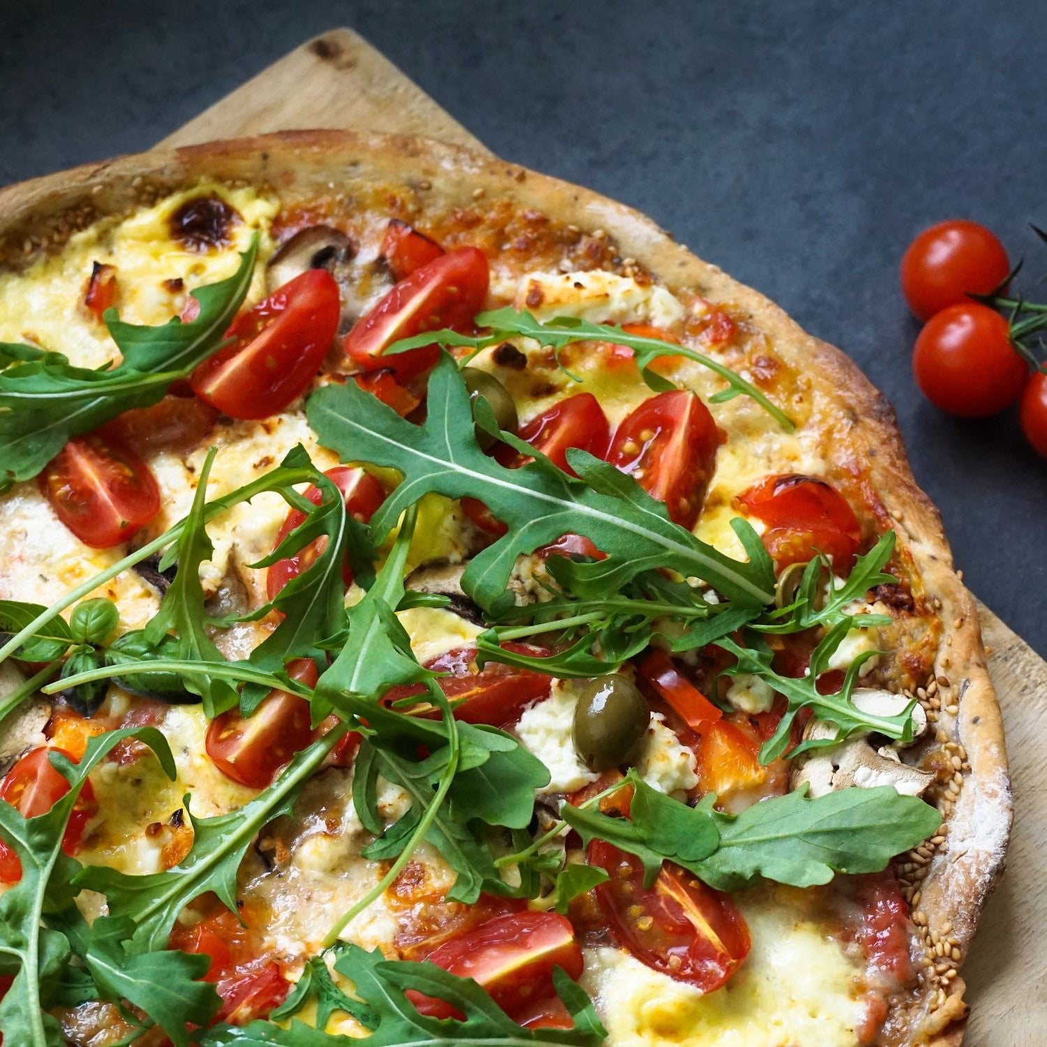 Pizza mit Rucola und Tomaten