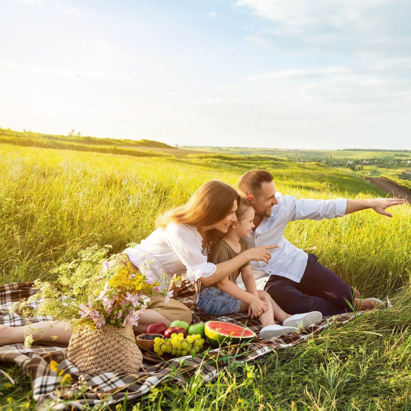 Familie macht ein basisches Picknick auf einem Feld